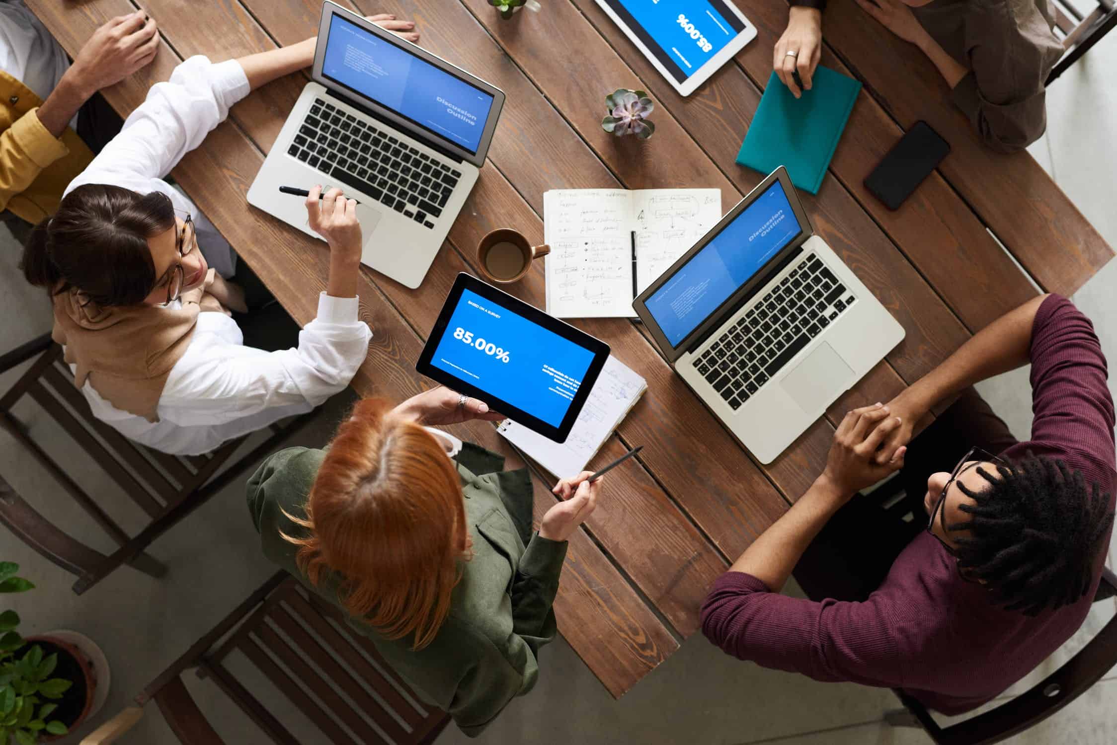 stock image showing a group of corporate employees sitting around a table doing business development